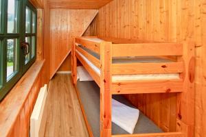 a wooden cabin with two bunk beds in it at Domek na Górce in Lądek-Zdrój