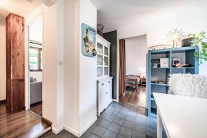 a kitchen and living room with a blue cabinet at Chalet Tante Emma proche Lac Leman in Vacheresse
