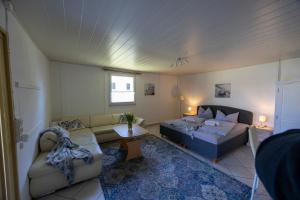 a living room with a couch and a bed at Ferienpark Buntspecht in Pruchten
