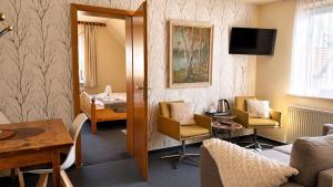 a living room with a couch and chairs and a table at Hotel Elisabeth Ilse in Braunlage