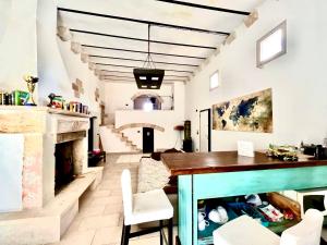 a living room with a table and a fireplace at Antica e luminosa masseria in Lequile