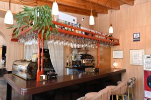 a bar in a restaurant with a shelf with wine glasses at Hotel Venta El Puerto in Murcia