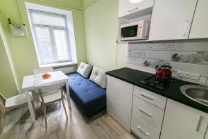 利沃夫利沃夫中心公寓的一间小房间的厨房,内配蓝色的沙发