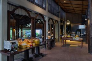 a lobby of a resort with a table filled with food at Homm Chura Samui in Chaweng