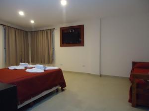 Una cama o camas en una habitación de Hosteria Torino