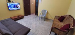 a living room with a couch and a chair at Carmel Stay in Madurai