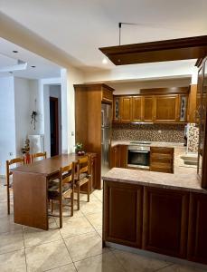 a kitchen with wooden cabinets and a wooden table at Lemon Zest in Nea Peramos