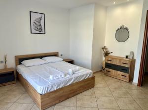 a bedroom with a bed and a mirror on the wall at Lemon Zest in Nea Peramos