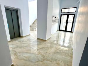 a hallway with marble flooring in a building at David Apart in Otopeni