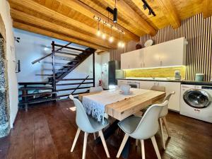 a kitchen with a wooden table and chairs at La Casa sull'Arco in Pacentro