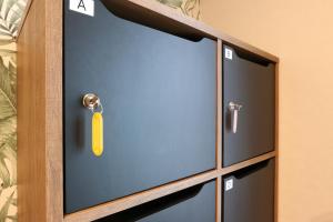 ein Schrank mit einem gelben Schlüssel daran in der Unterkunft Re AERU in Minamiboso