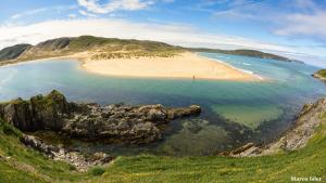 an aerial view of a beach on the coast at Bettyhill Hotel in Bettyhill