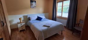 a small bedroom with a bed and a window at Wooly Lodge in Westport