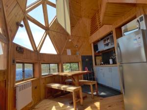 a kitchen and dining area of a tiny house at Dune & Domes Pichilemu in Pichilemu