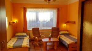 a room with two beds and a window at Apartment U Pošty in Lipova Lazne