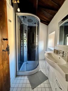 a bathroom with a shower and a sink at La Casa sull'Arco in Pacentro +29 photos
