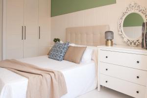 a bedroom with a bed with a mirror and a dresser at Mar de Louro in Muros