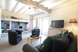 a living room with a couch and a tv at Labourdette in Lasseube
