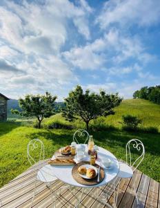 a table with a plate of food on top of a field at Labourdette in Lasseube +29 photos