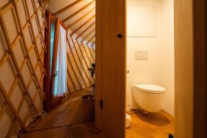 a bathroom with a toilet in a attic at ASTRAEA Jurt Village in Arendsee +14 photos