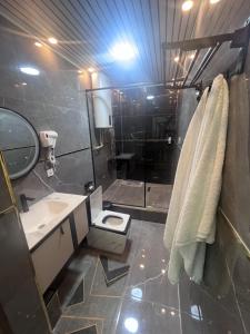 a bathroom with a shower and a sink and a toilet at Pamir Silk Road in Qala-i-Khum +19 photos
