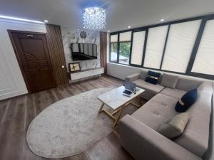 a living room with a couch and a table at Pamir Silk Road in Qala-i-Khum