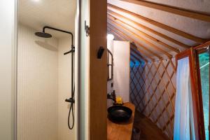 a bathroom with a shower and a sink in a room at ASTRAEA Jurt Village in Arendsee