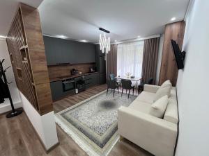 a living room with a white couch and a table at Pamir Silk Road in Qala-i-Khum