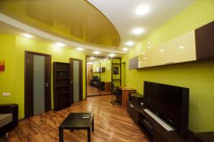 a living room with yellow walls and a flat screen tv at Apartment on Pushkina in Kazan