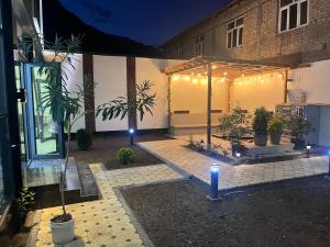 a lit up courtyard with a tent and lights at Pamir Silk Road in Qala-i-Khum