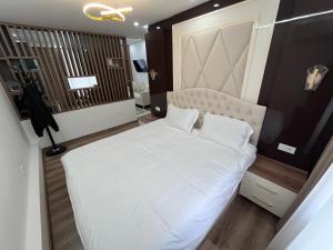 a bedroom with a large white bed in it at Pamir Silk Road in Qala-i-Khum