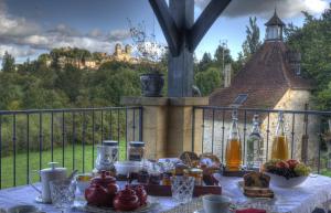 a table with food and drinks on a balcony at La Villa du Mont in Gourdon +6 photos