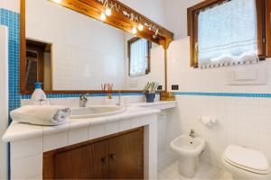 a bathroom with a sink and a toilet at Paradiso San Giacomo in Cogorno +37 photos