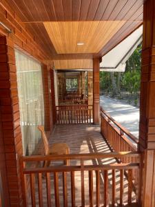 a porch of a home with a wooden deck at Jungle Beach Resort in Neil Island