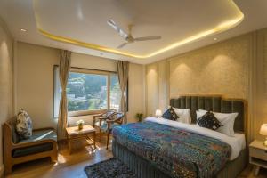 a hotel room with a bed and a window at Tripli Hotels Royal Spring in Mussoorie +44 photos