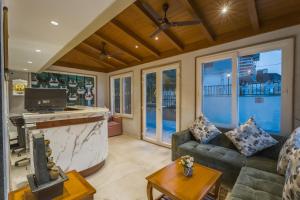 a living room with a couch and a bar at Tripli Hotels Royal Spring in Mussoorie