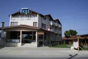a large white building with a sign on it at Hotel Akre in Kavarna