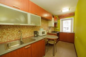 a small kitchen with a sink and a microwave at Apartment on Pushkina in Kazan