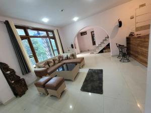 a living room with a couch and a table at Vikas Hotel And Restaurant in Barot 