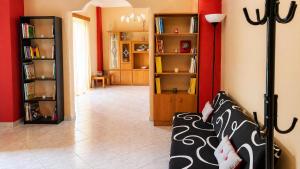 a living room with a couch and book shelves at Vens apartment 90m2 at Eantio bay. in Aiándion