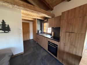 a kitchen with wooden cabinets and a stove top oven at Le mazot in Lens