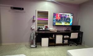 a room with a desk with a tv on a wall at Sasang Goyohan-hotel in Busan +11 photos