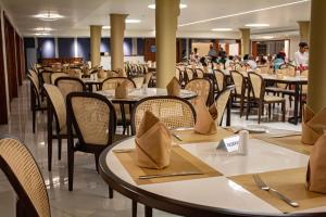 a dining room filled with tables and chairs at Rajarata Hotel Anuradhapura in Anuradhapura