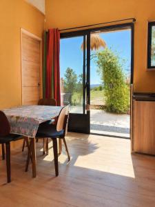 a dining room with a table and a large window at le clos d'Yrem in La Rochegiron