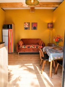 a living room with a couch and a table at le clos d'Yrem in La Rochegiron