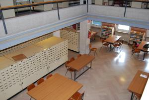 an overhead view of a classroom with tables and chairs at Cittadella Laudato Si' in Assisi