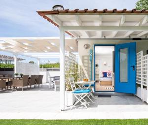 a patio with a blue door and a table at Nautical Toroni Rooms in Toroni
