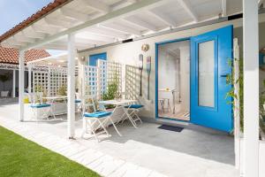 a pergola with chairs and tables on a patio at Nautical Toroni Rooms in Toroni +117 photos