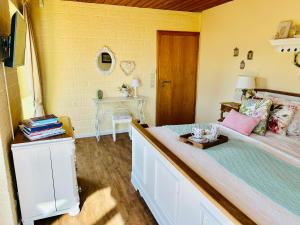 a bedroom with a large bed and a table at Castles Corner Bad Fallingbostel in Bad Fallingbostel