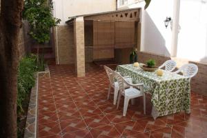 a patio with a table and chairs and a fireplace at Casa Galisa in Torrevieja